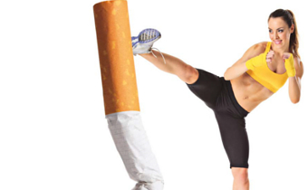 A woman gives an over sized cigarette a kick.