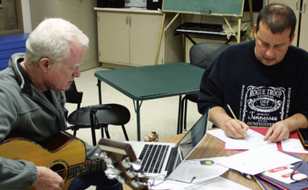 Veteran Todd Foster (right) writes lyrics during a song writing session with Volunteer and Grammy award winning songwriter Bob Ragan.