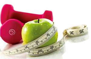 An image of an apple, wrapped with a tape measure, with hand weights in the background.
